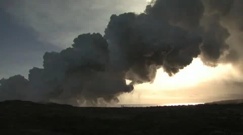 Giant Steam Cloud Obscures The Sun As Two Men Walk Across A Lava Field 2 Video stock 19286092