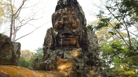 Giant stone faces at the top of Angkor Thom gate, Siem Reap, Cambodia. Stock Footage 106708416