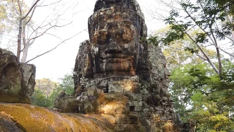 Giant stone faces at the top of Angkor Thom gate, Siem Reap, Cambodia. Stock Footage 106708668