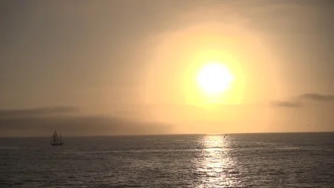 Giant Sunset Over Ocean with Boat Stock Footage 80358953