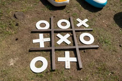 Giant tic-tac-toe game set up on grass outdoors with inflatable boats in Foto stock