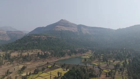 Giant view of mountain with small lake and farm land. Stock Footage 255280992