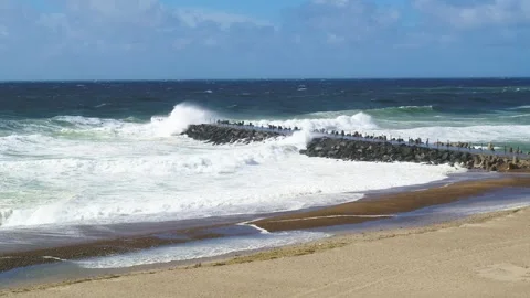 Giant waves crashing hitting a pier at the North Sea in Denmark Stock Footage 335996474