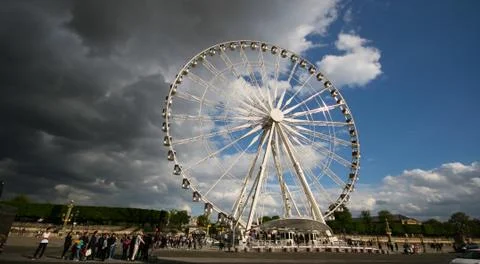 Giant wheel in Paris in Cloudy and sunny day Stock Photos