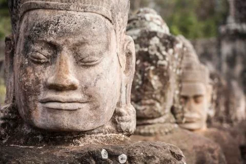 Giants in front gate of angkor thom Stock Photos