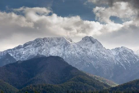 Giewont Mountain in polish Tatra Mountains covered with snow under cloudy sky Stock Photos