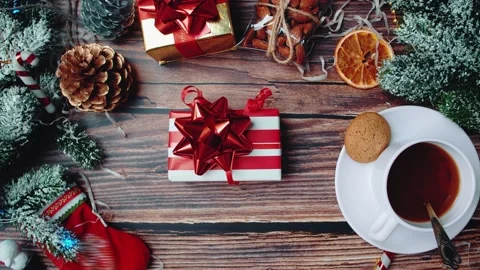 A gift with a bow is placed on a wooden table in the atmosphere of Christmas, Stock Footage 145163855