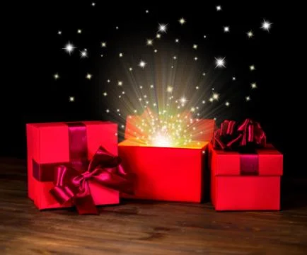 Gift box and bow is opened with fairy tale miracle is isolated on black backg Fotos de archivo