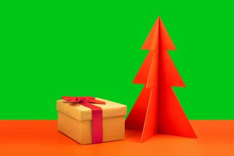 Gift box and envelope with red wodden Christmas tree on brown background Stock Photos