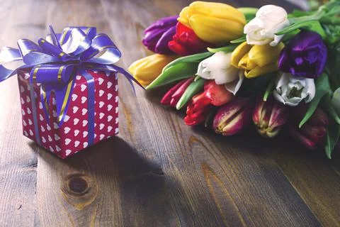 Gift box and  tulips Stock Photos