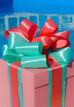 Gift box on the background of the pool. Stock Photos