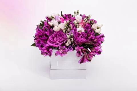 Gift box with beautiful flowers on white background. Flower box with spring f Stock Photos