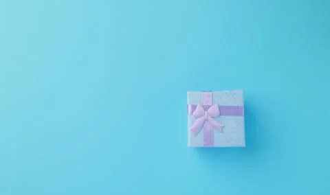 Gift box on blue a background. Concept of a gift for Christmas, birthday, Stock Photos