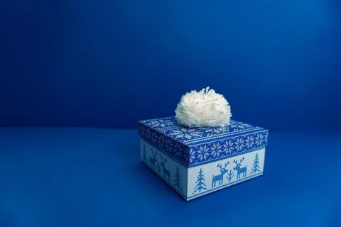 Gift box on blue background. Stock Photos
