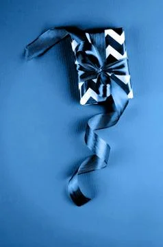 Gift box on a blue background Photos