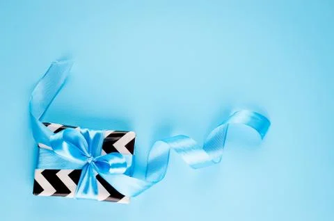 Gift box on a blue background Stock Photos