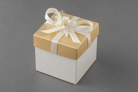 Gift box with bow on gray background. Stock Photos