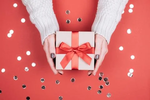 Gift box with bow in woman's hands. Stock Photos