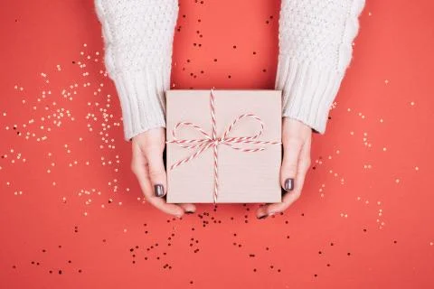 Gift box with bow in woman's hands. Stock Photos