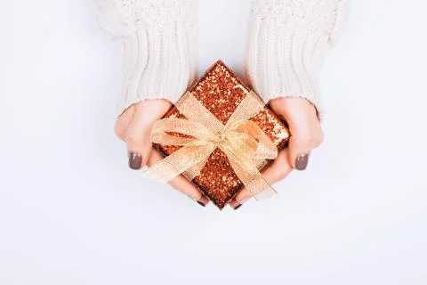 Gift box with bow in woman's hands. Stock Photos
