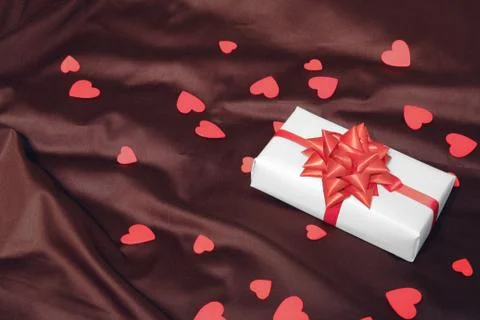 Gift box on brown background Stock Photos