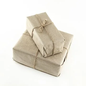 Gift box in brown paper stack on white isolated background Stock Photos