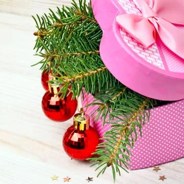 Gift box with christmas baubles and pinetree Stock Photos