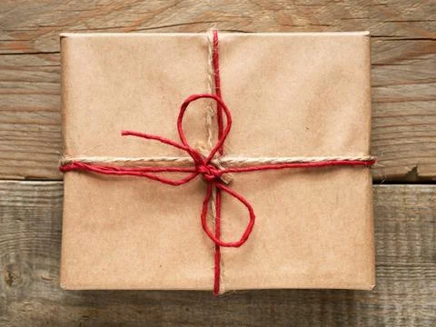 Gift box close-up top view on wooden background 스톡 사진