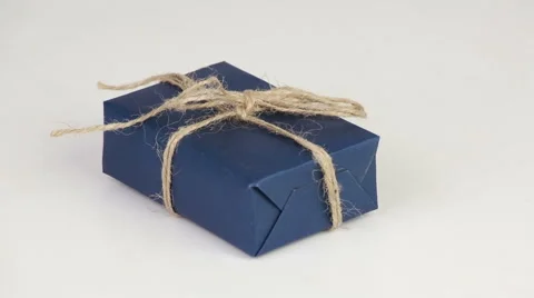 Gift box covered with blue wrapping paper Stock Footage 58888411