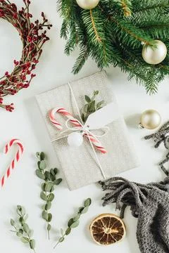 Gift box decorated with candy, eucalyptus, tag; wreath frames made of fir bra Fotos de archivo