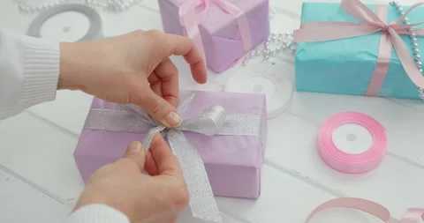 Gift box decoration. Hands are wrapping holiday surprises. Stock Footage 144274205