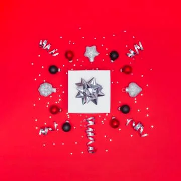 Gift box with decorations on red background Stock Photos