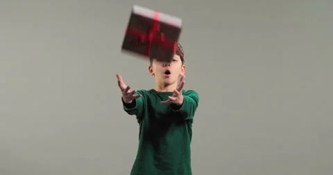 Gift box fall into kid's hands. Excited boy Stock Footage 286052298