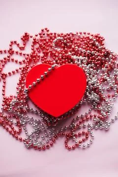 Gift box on the festive blurred background. Red heart. Valentine's Day gift. Stock Photos