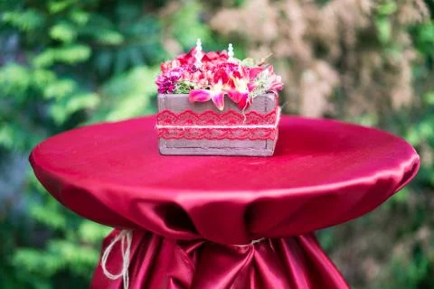 Gift box with flowers on red background Stock Photos