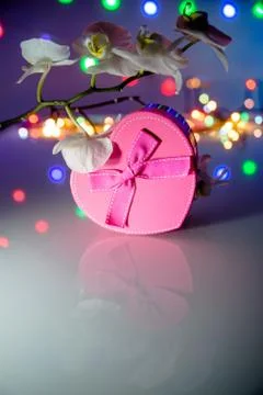 Gift box in form of heart on the background of the white orchid 写真素材