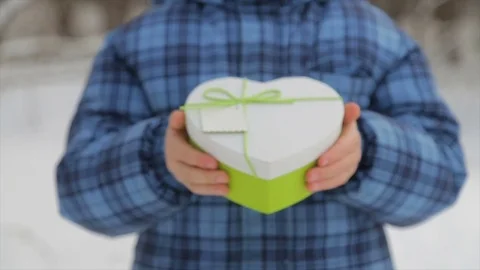 Gift box in the form of a heart in the hands of a child Stock Footage 84742844