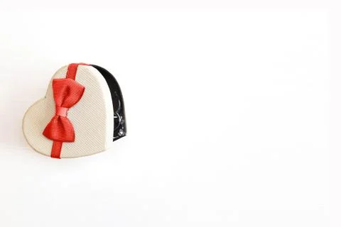 Gift box in the form of a heart with a red bow on a white background. place f Stock Photos