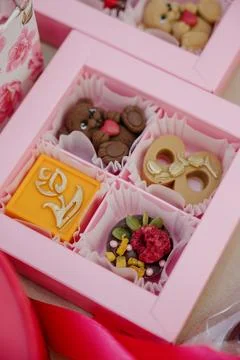 A gift box with handmade teddy bear-shaped chocolates and decorative elements Stock Photos