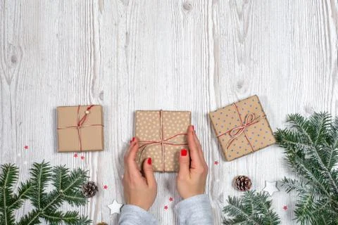 Gift box in hands with Christmas background Stock Photos