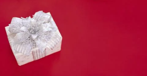 Gift box is isolated on a red background with copy space Foto stock
