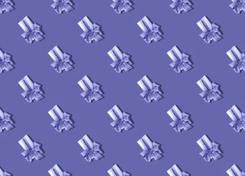 A gift in a box with a large bow, painted background in the color of veri peri. Stock Photos