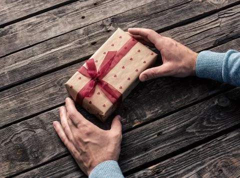Gift box in man's hands Stock Photos
