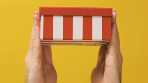 Gift box moves from bottom to top. Hands hold the gift box Video stock 172491353