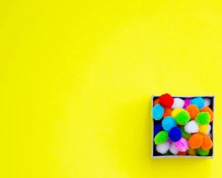 Gift box with multi-colored confetti on a yellow background. Foto stock