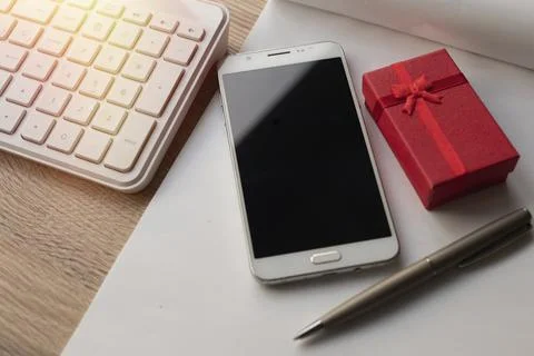 Gift box with notebook, computer and smartphone Stock Photos