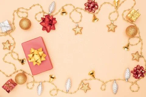Gift box or present box with golden star, bell and ball on golden background  Foto stock