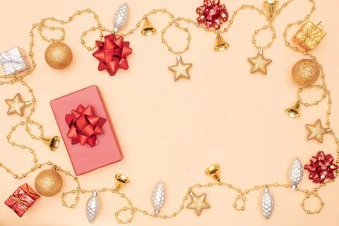 Gift box or present box with golden star, bell and ball on golden background  Stock Photos