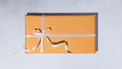 Gift box or present wrapped in craft paper. Holiday present. Copy space. Stock Photos