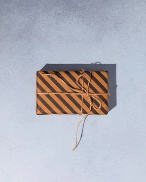 Gift box or present wrapped in craft paper. Holiday present. Copy space. Stock Photos